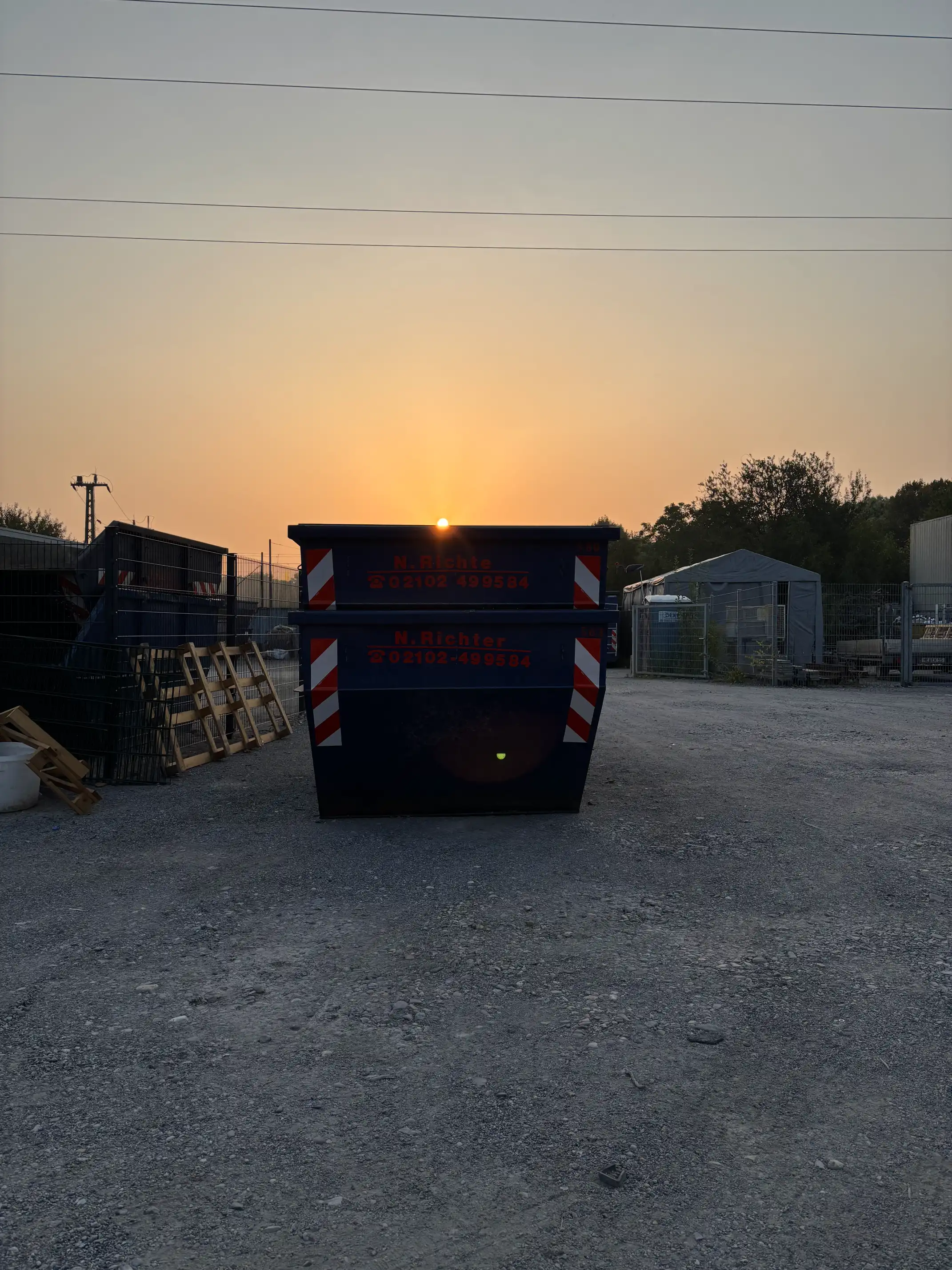 Ein Container mit dem Sonnenaufgang im Hintergrund